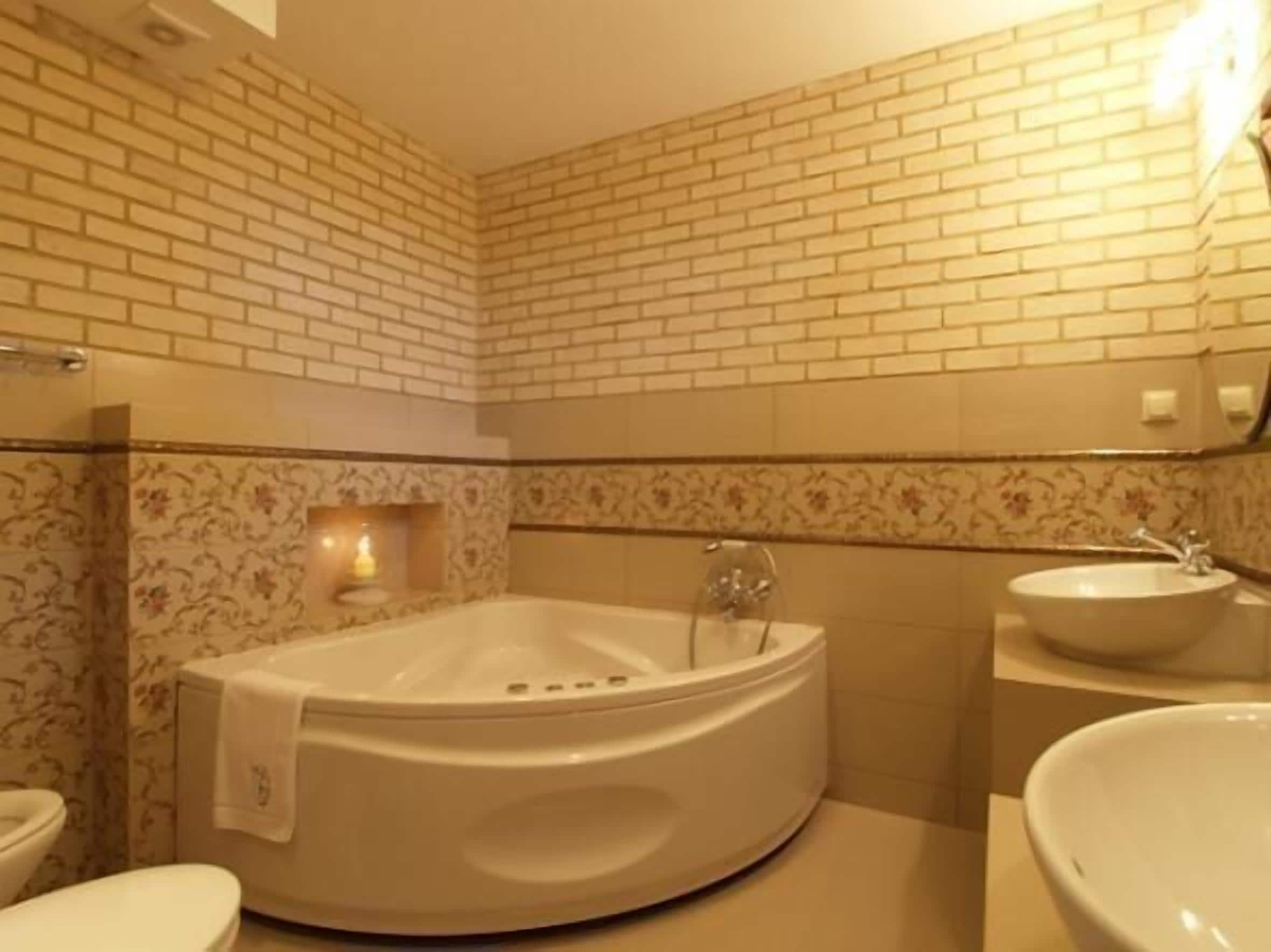 A bathroom with a freestanding bathtub, a toilet, and a sink.