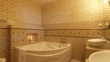 A bathroom with a freestanding bathtub, a toilet, and a sink.