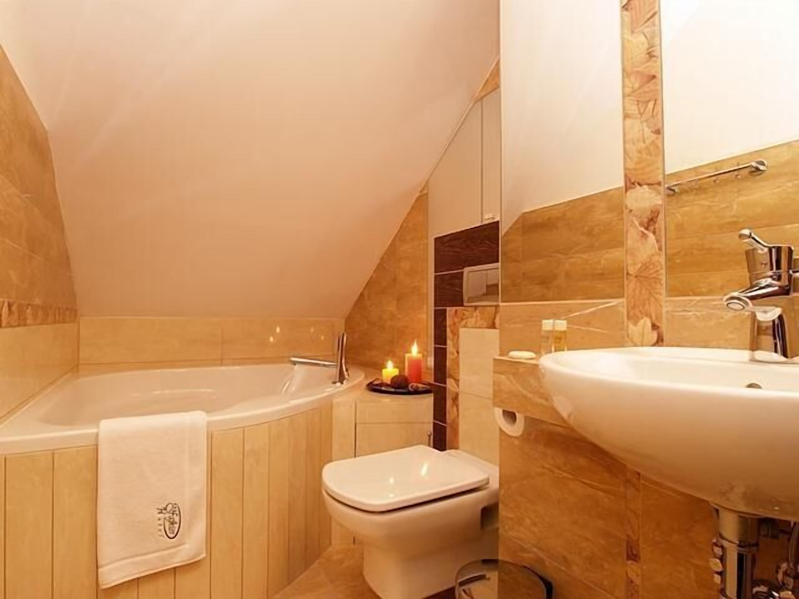 spring water bathtub, designer toiletries, hair dryer, slippers