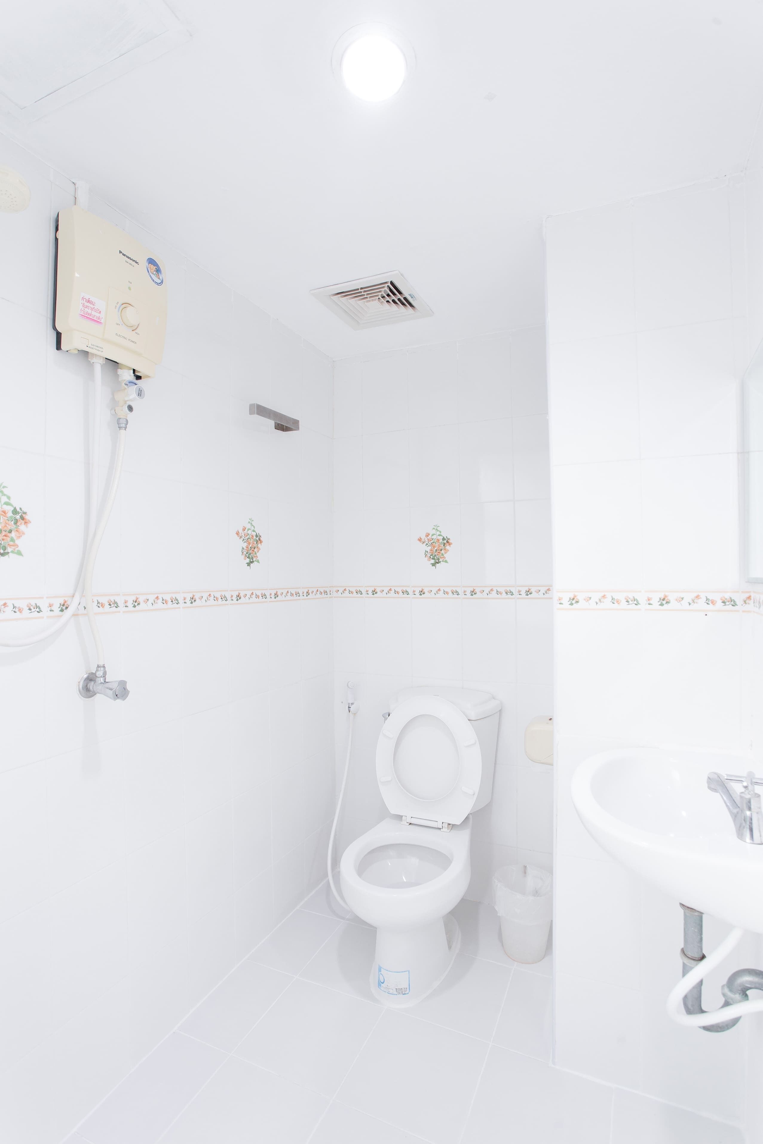 A white bathroom with a toilet, bidet, and sink.