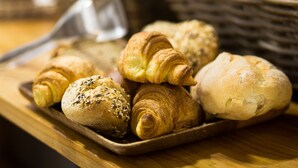 A tray of assorted pastries on a wooden table.