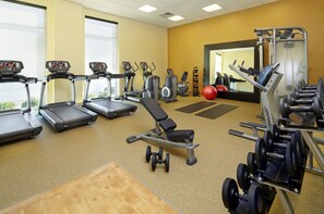 Stay fit and active with our well-equipped gym featuring treadmills, elliptical machines, a bench press, and dumbbells.