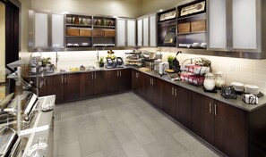Prepare meals in this fully equipped kitchen with a stainless steel sink, ample counter space, and a waffle maker.