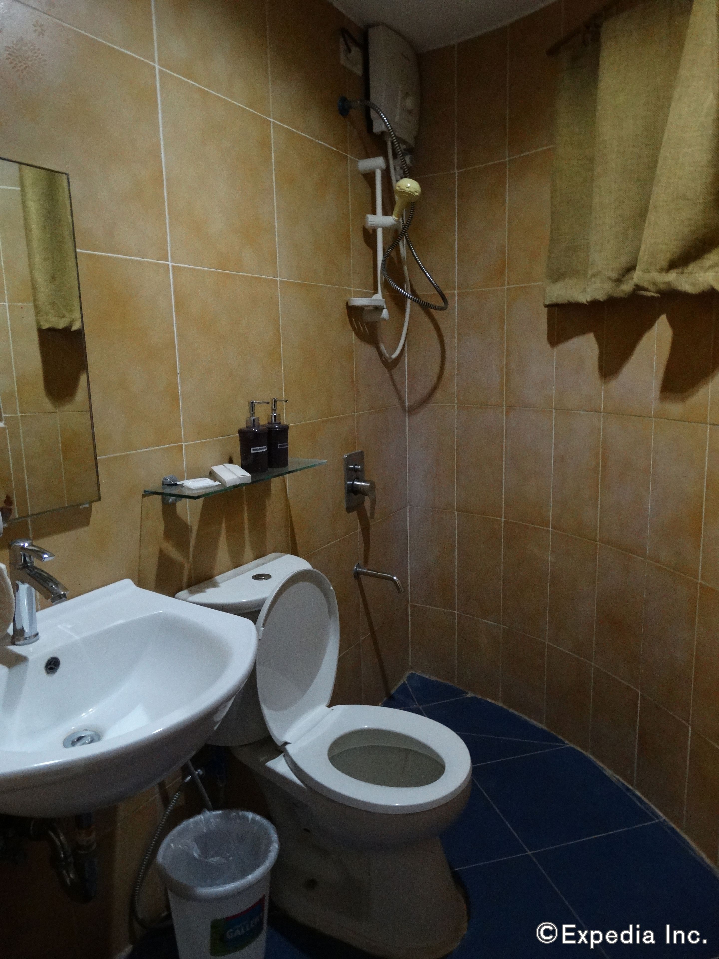 A bathroom with a sink, toilet, and shower.