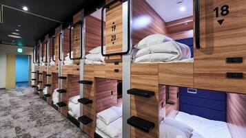 A hotel room with bunk beds, each marked with a number.