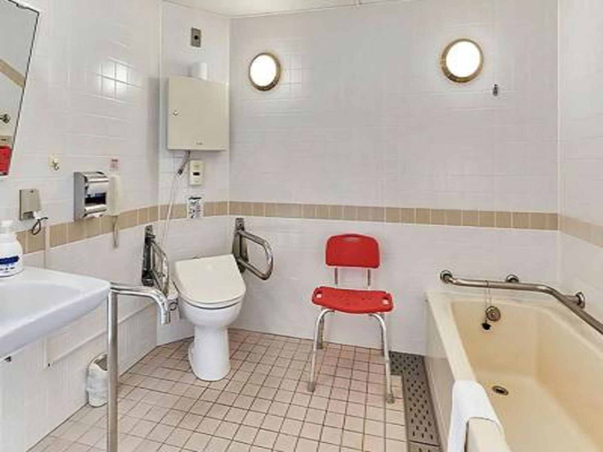 A bathroom with a toilet, sink, and bathtub.