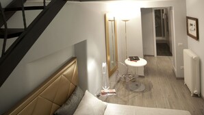 A bedroom with a bed, a nightstand, a small table, a mirror, and a staircase with a railing. - Luxury on the River (Rome)