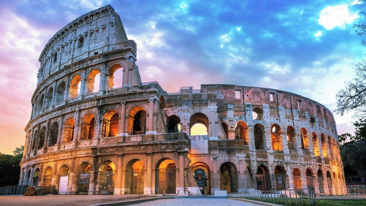 A historic coliseum with multiple arches and a large central structure.