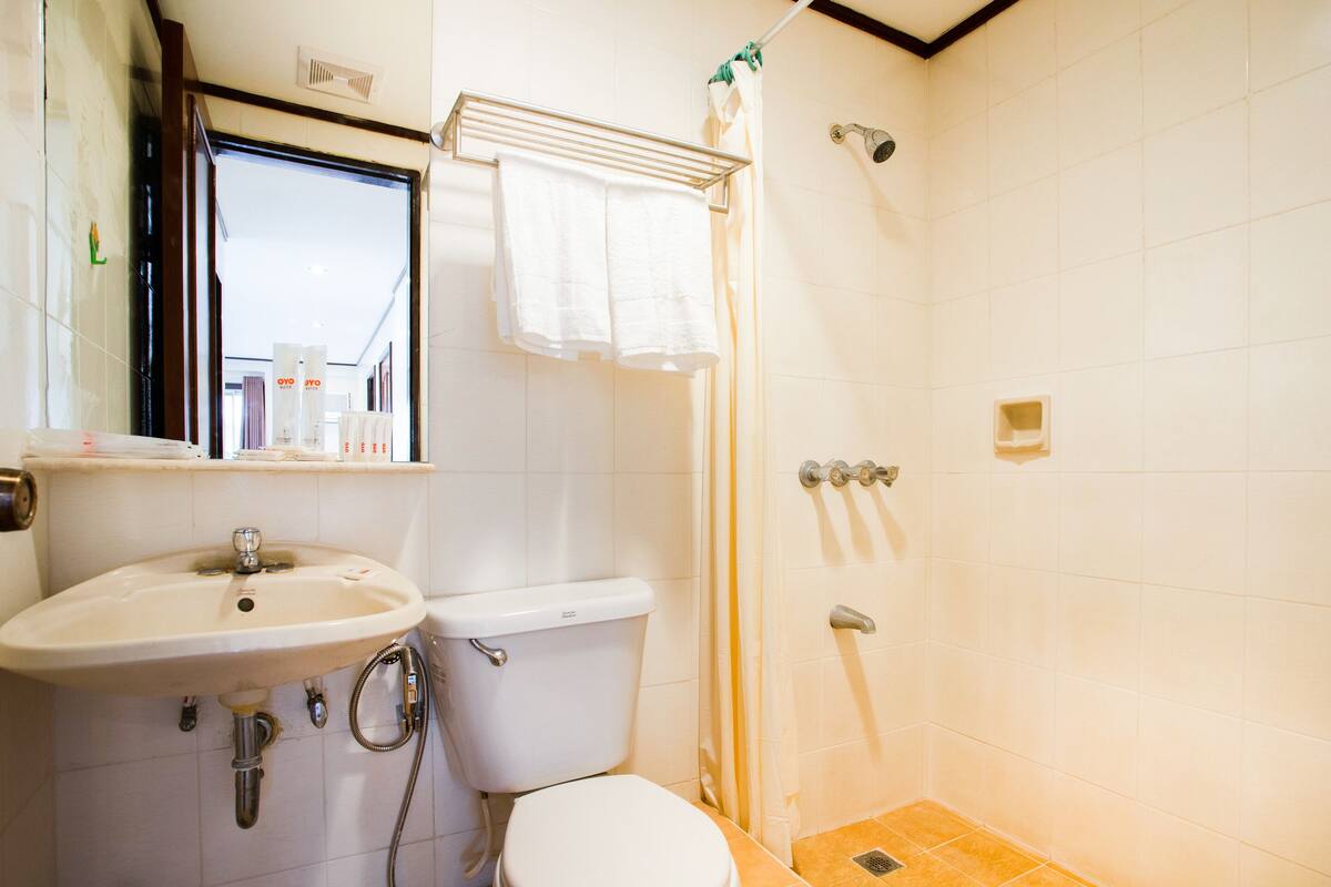 A bathroom with a sink, toilet, and shower.