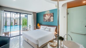 A modern hotel room with a large bed, a bathroom with a glass shower, and a view of a swimming pool. - The Pago Design Hotel Phuket (Ratsada)