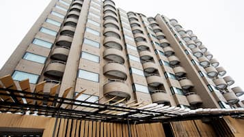 A high-rise building with multiple balconies and a modern architectural design.