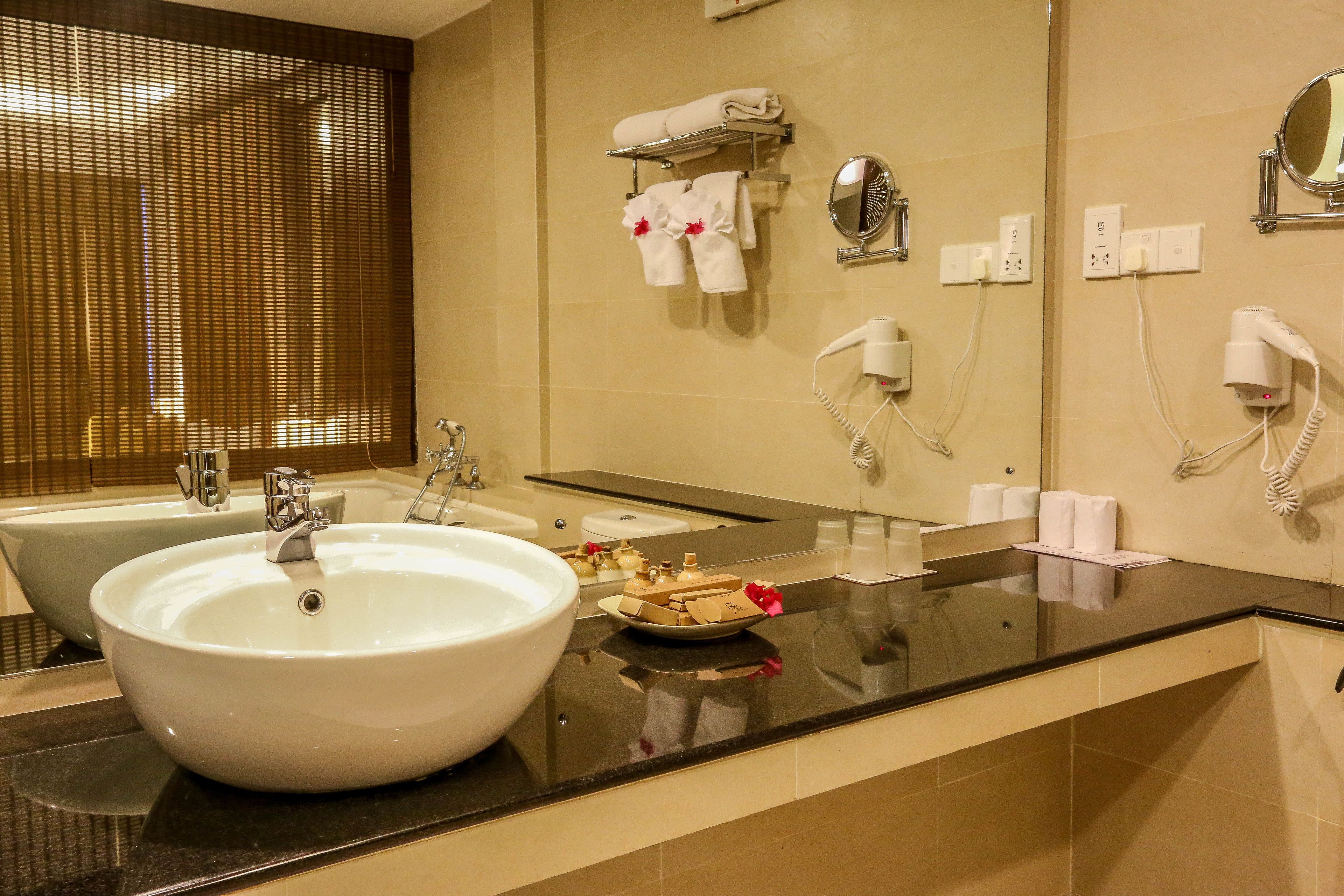 deluxe twin room | bathroom | hair dryer, slippers, bidet, towels