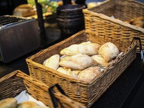 Wicker baskets filled with bread on a table.