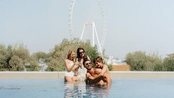 Outdoor pool, open 10:00 AM to 6:00 PM, pool umbrellas, pool loungers