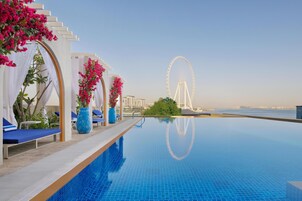 Outdoor pool, open 10:00 AM to 6:00 PM, pool umbrellas, pool loungers