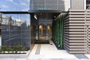 A modern hotel entrance with a glass facade, a visible reception area, and a name sign above the door. - Sotetsu Fresa Inn Shimbashi Hibiyaguchi (Tokyo)