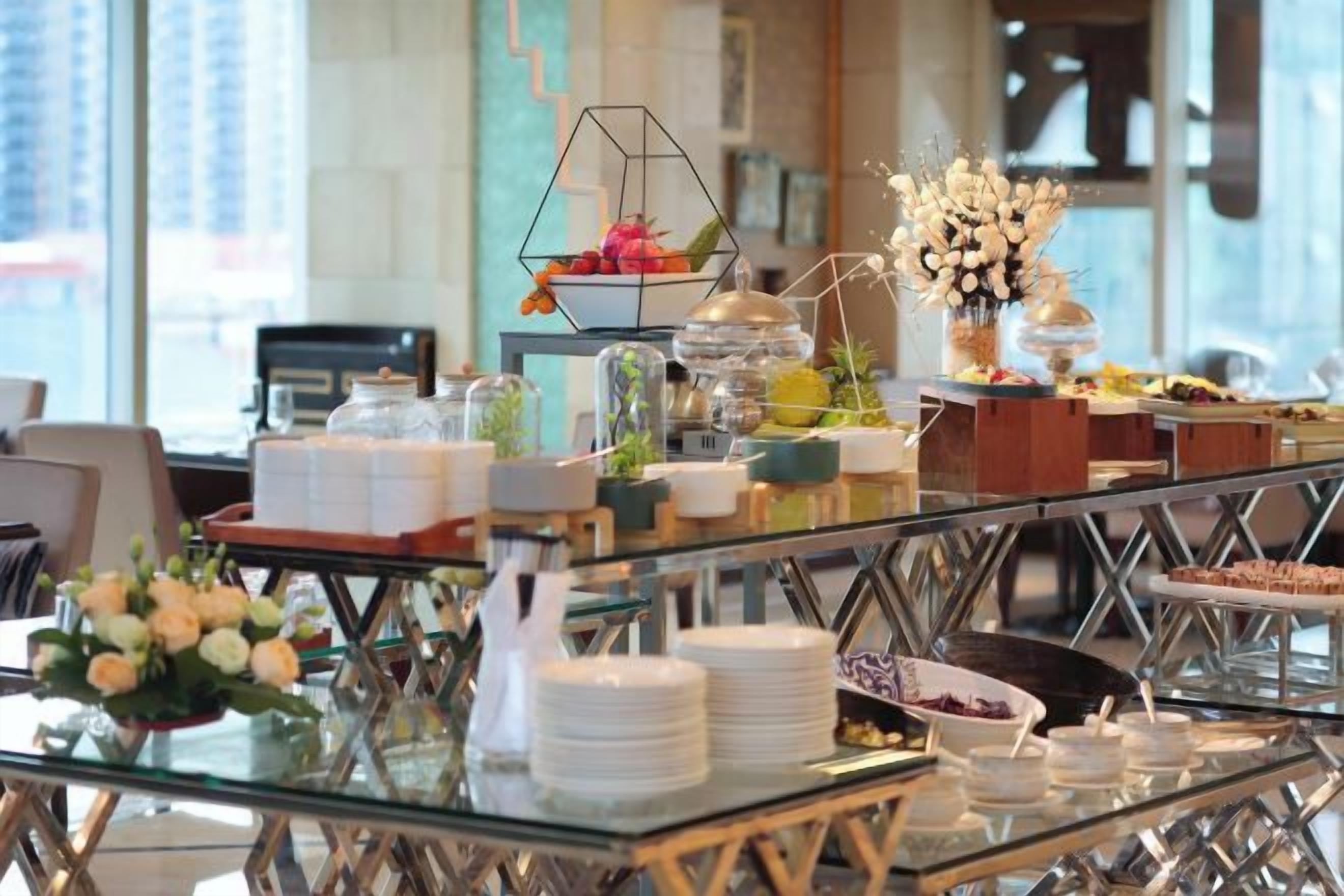 A buffet setup with various food items and a decorative centerpiece.