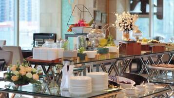 A buffet setup with various food items and a decorative centerpiece.