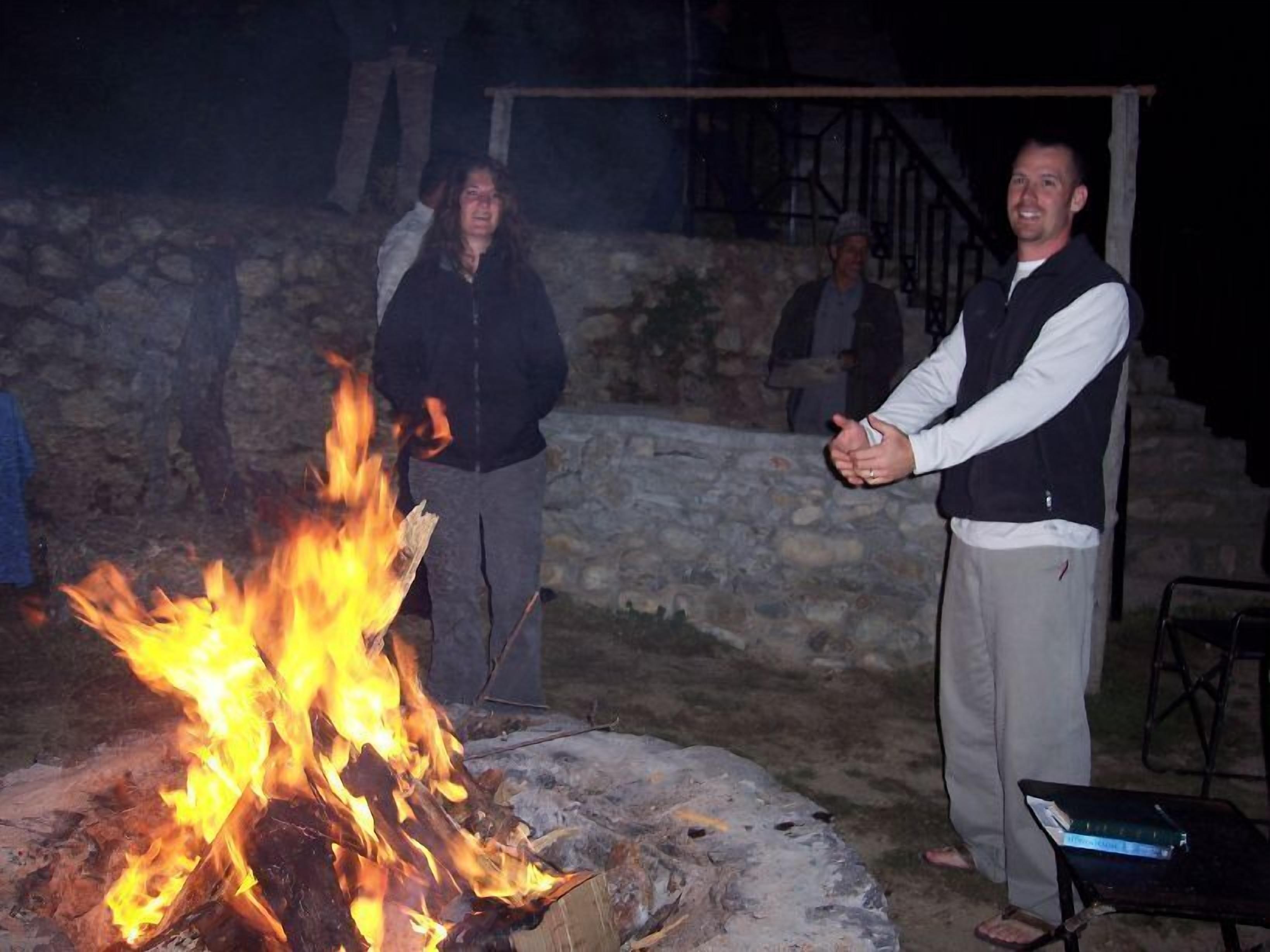 A stone wall and a fire pit in an outdoor setting.