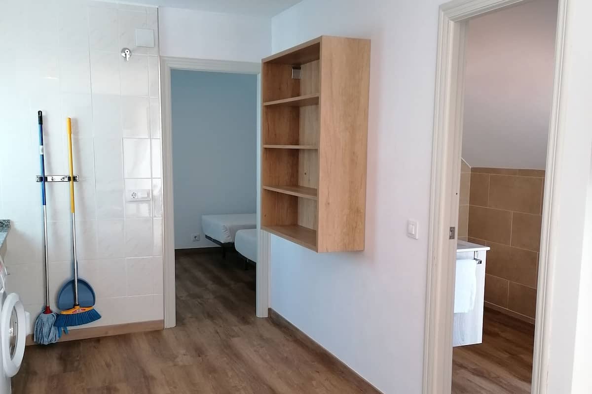 A clean, modern bathroom with a toilet, a shower, and a sink.