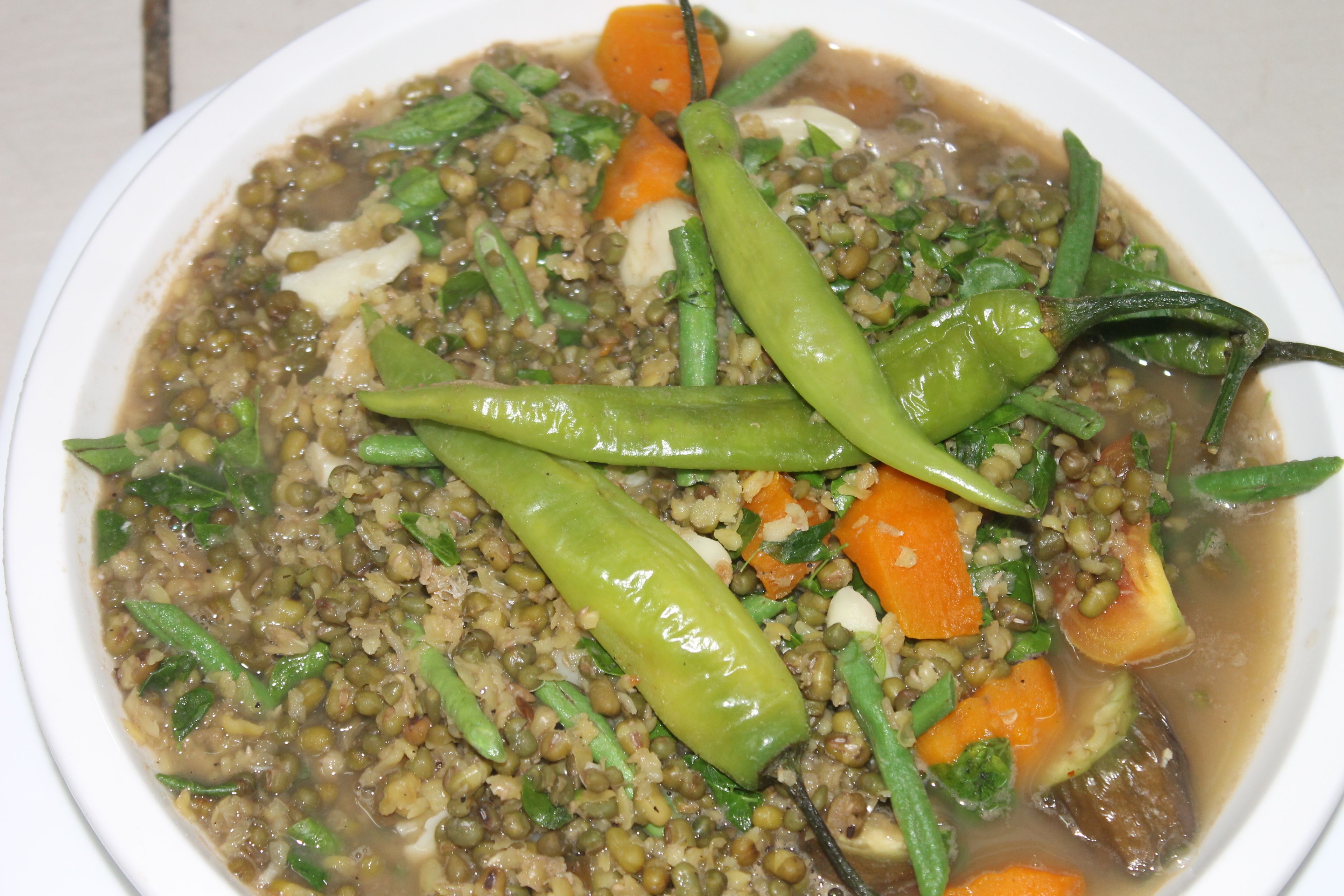 A bowl of lentil soup with vegetables.