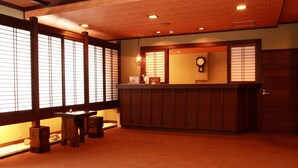 A traditional Japanese-style reception area with sliding doors, a reception desk, and a clock on the wall. - Hodakaso Yamanoiori (Takayama)