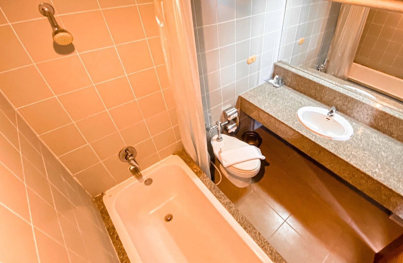 A bathroom with a bathtub, two sinks, and a shower.