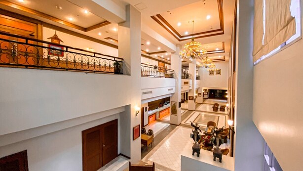 A multi-level hotel lobby with a grand staircase, chandeliers, and a spacious seating area. - K Park Grand Hotel (Surat Thani)