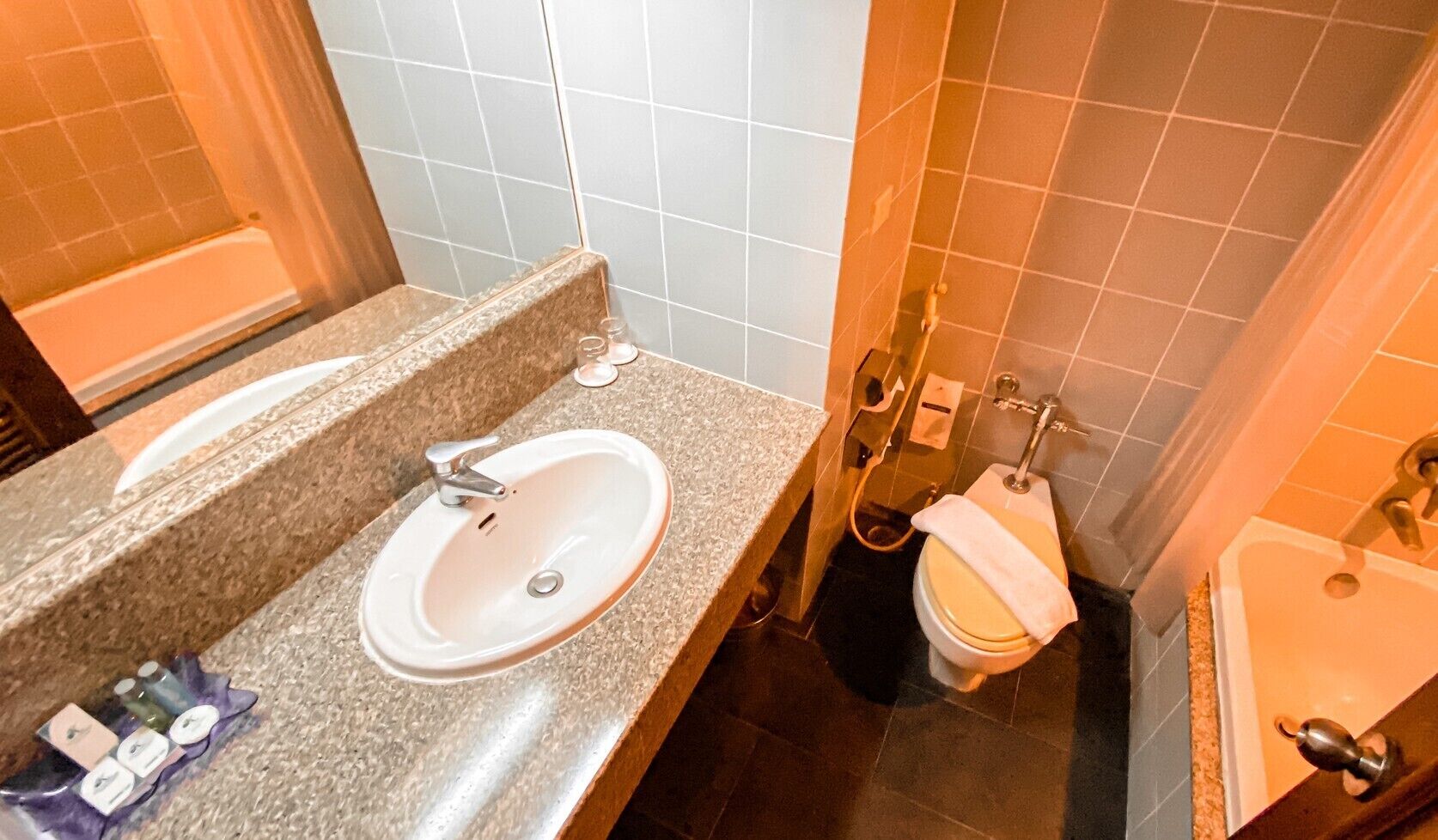 A bathroom with a sink, toilet, and shower.