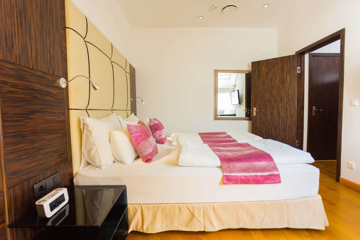 A bedroom with a bed, bedside table, and wardrobe.