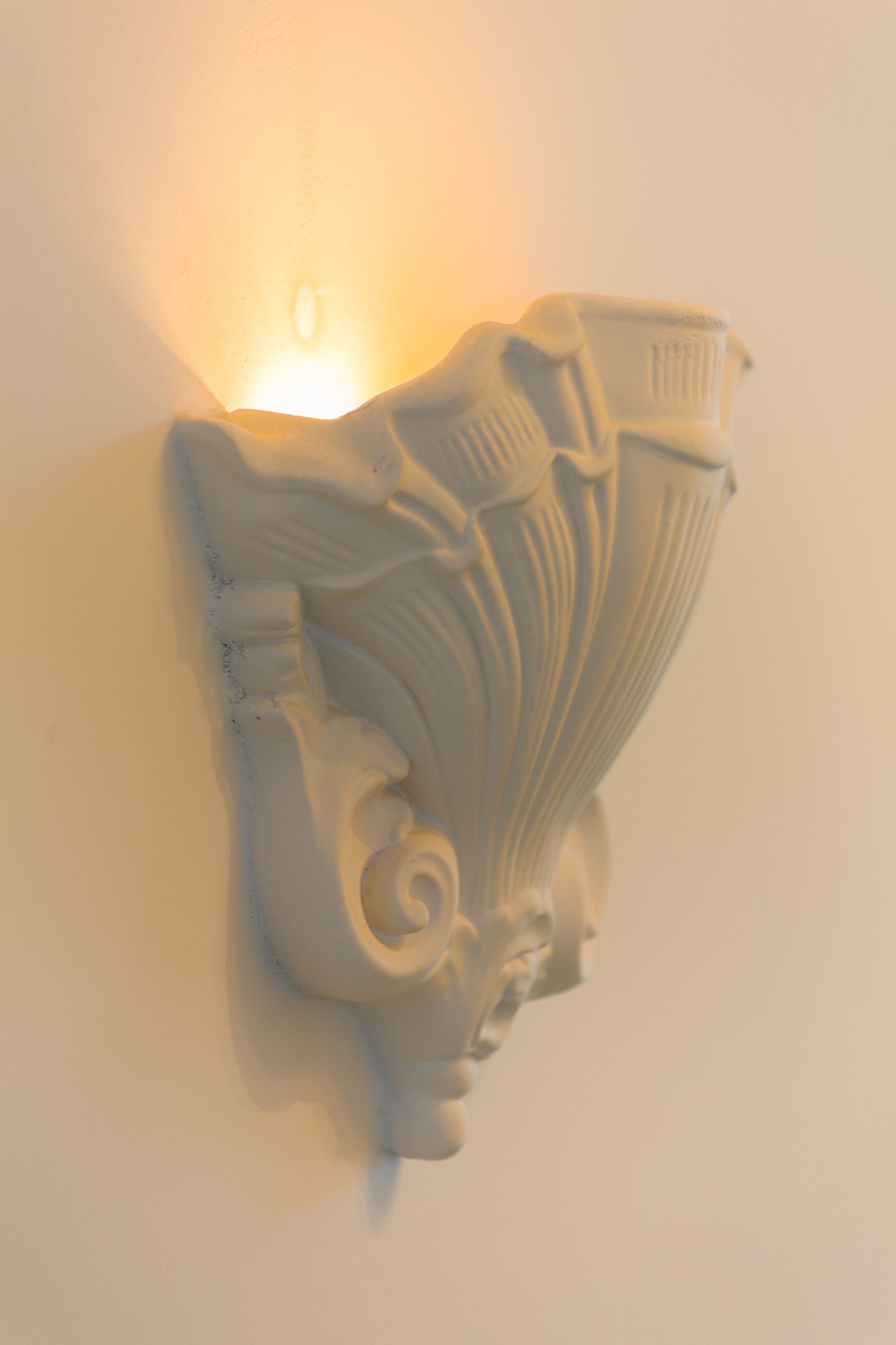 A wall-mounted light fixture with intricate designs.