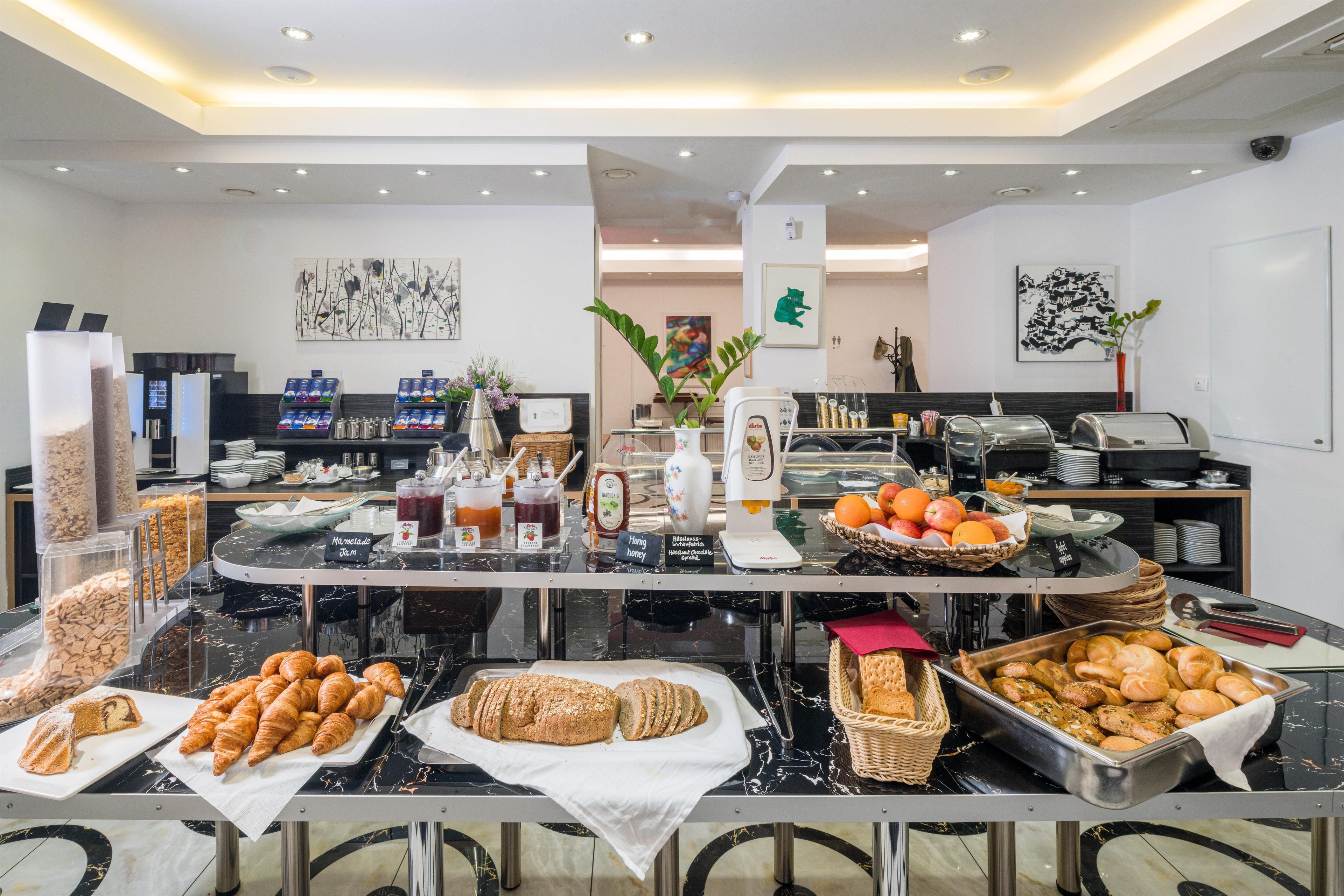 A buffet setup with various food items and beverages.