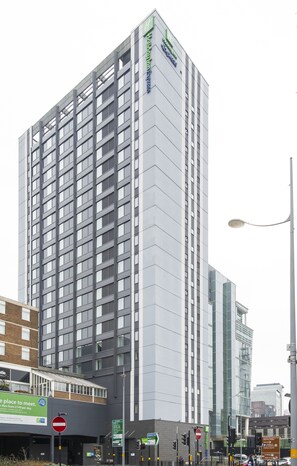 A tall hotel building with a modern design, featuring a prominent sign for Hilton Hotels. - Holiday Inn Express Birmingham - Snow Hill by IHG (Birmingham)