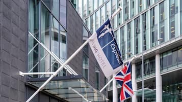 A flag with 'ANIING HOTEL' and 'Express' text, a British flag, and a modern building with large windows.
