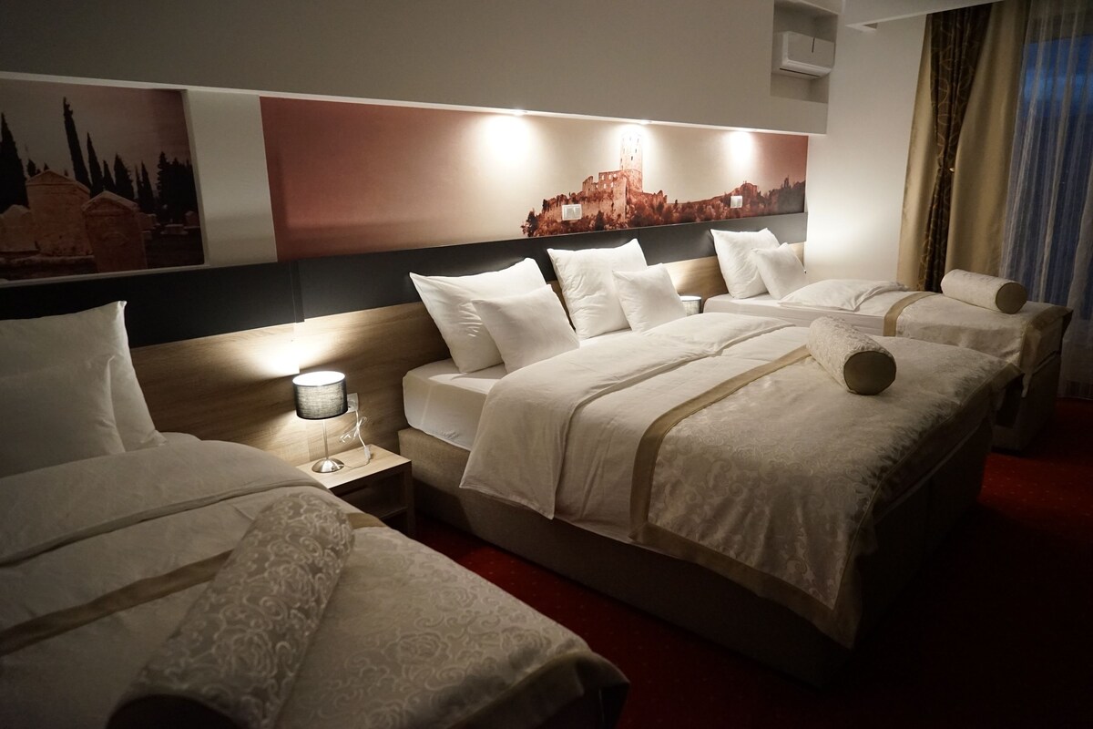 Deluxe Quadruple Room | Premium bedding, in-room safe, desk, blackout drapes