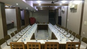 A conference room with a long table, chairs, and water bottles. - Hotel Landmark-Haridwar (Haridwar)