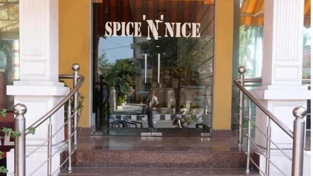 A staircase leading to a restaurant entrance with a sign reading "SPICE N' NICE". - Hotel Landmark-Haridwar (Haridwar)