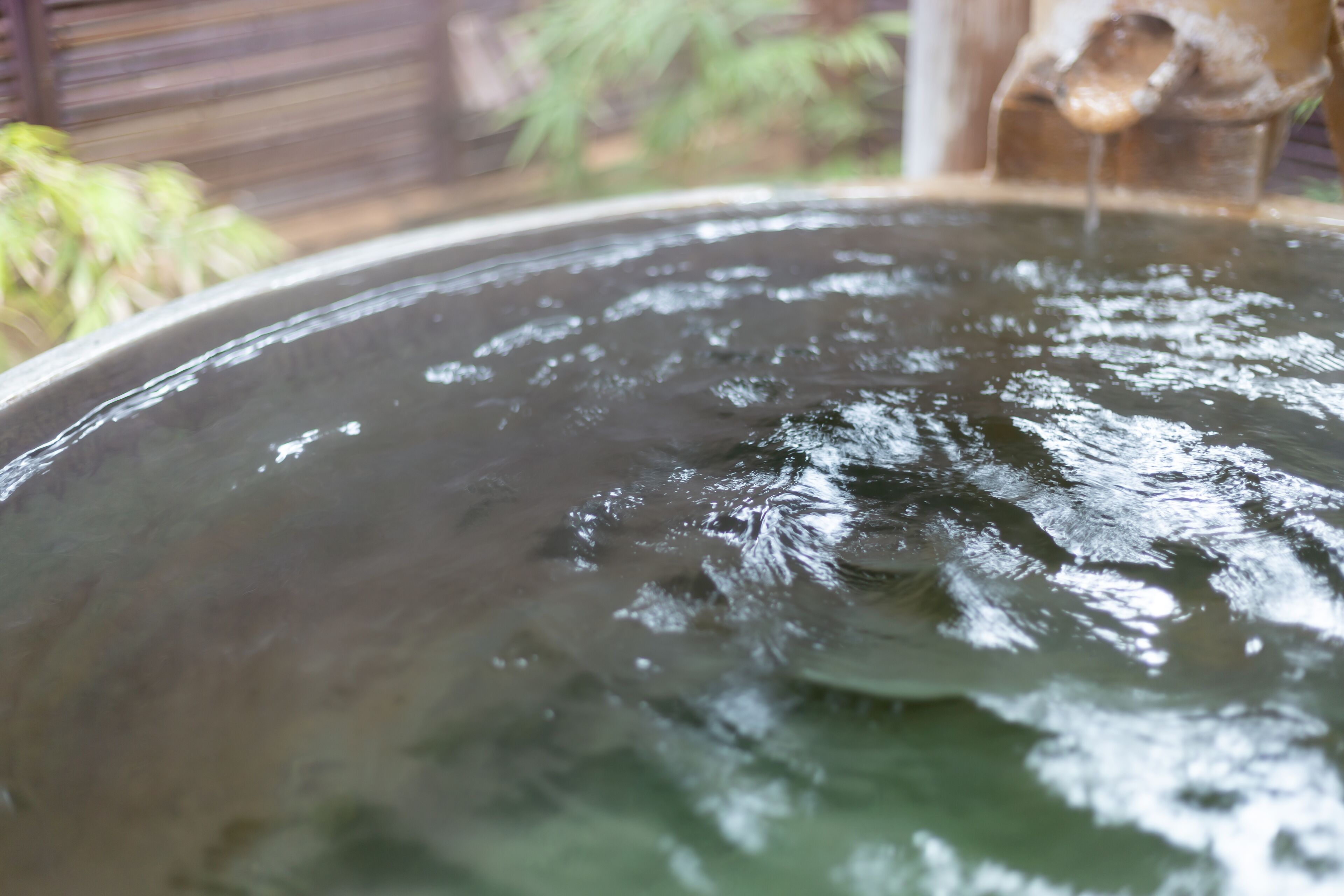 A large, round water feature with a central spout.