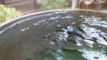 A large, round water feature with a central spout.