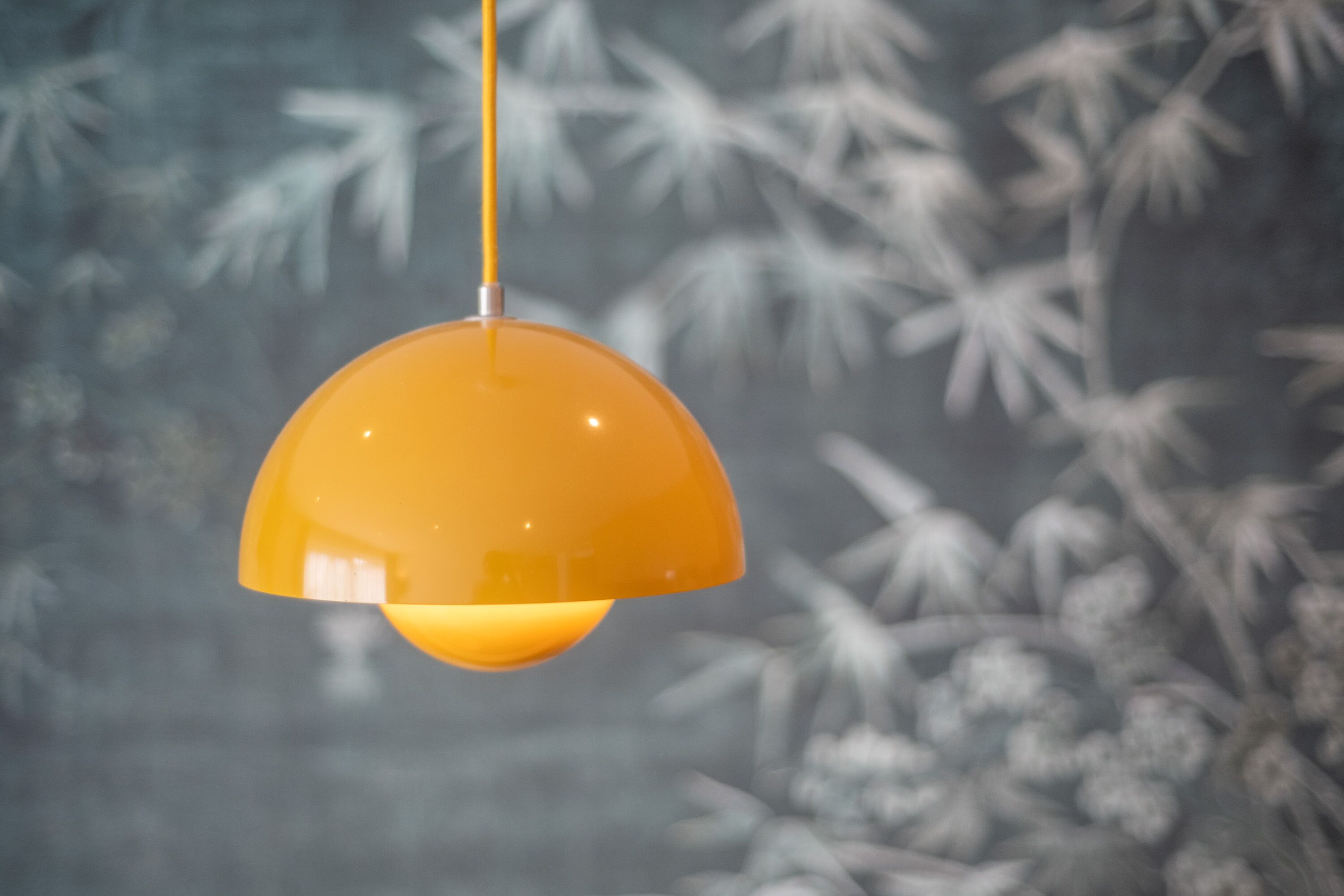 A hanging orange pendant light fixture.