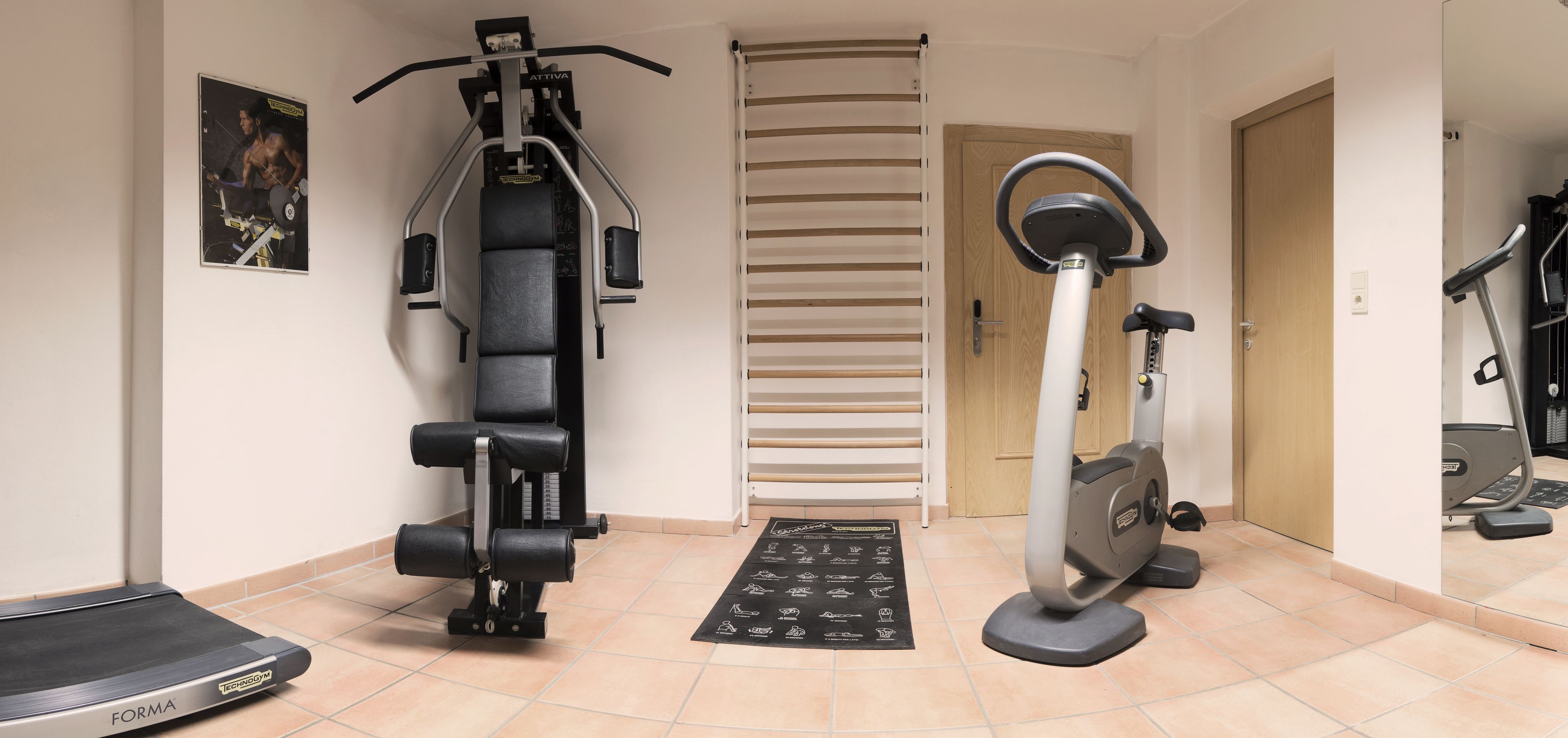A home gym with a treadmill, elliptical, and weight machine.