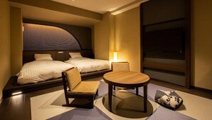 A hotel room with two beds, a small table, a chair, and a TV. - Yumoto Niseko Prince Hotel Hirafutei (Kutchan)