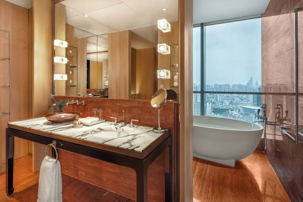 separate bathtub and shower, rainfall showerhead, designer toiletries