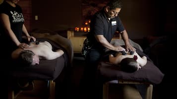 Experience a rejuvenating massage in a serene space with two massage tables and expert therapists.
