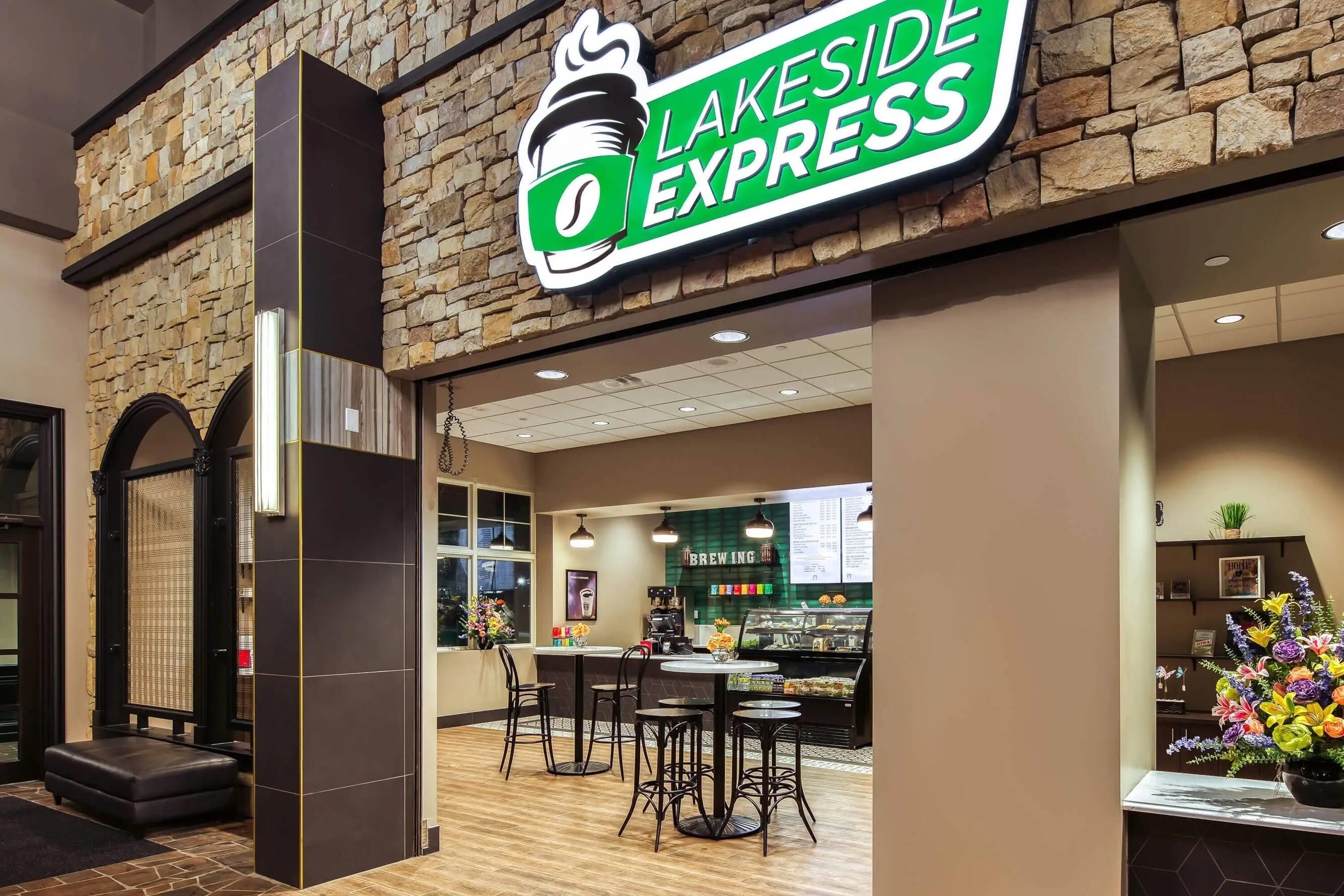A Lakeside Express coffee shop with a stone facade, a coffee bar, and seating area.