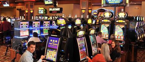 A casino with multiple slot machines and a 'HOT SPIN' sign.