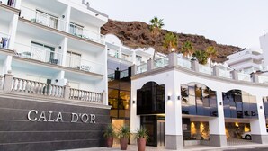 A hotel with a prominent sign reading "CALA D'OR" and a modern architectural design with balconies and large windows. - Apartamentos Cala D'Or (Mogan)