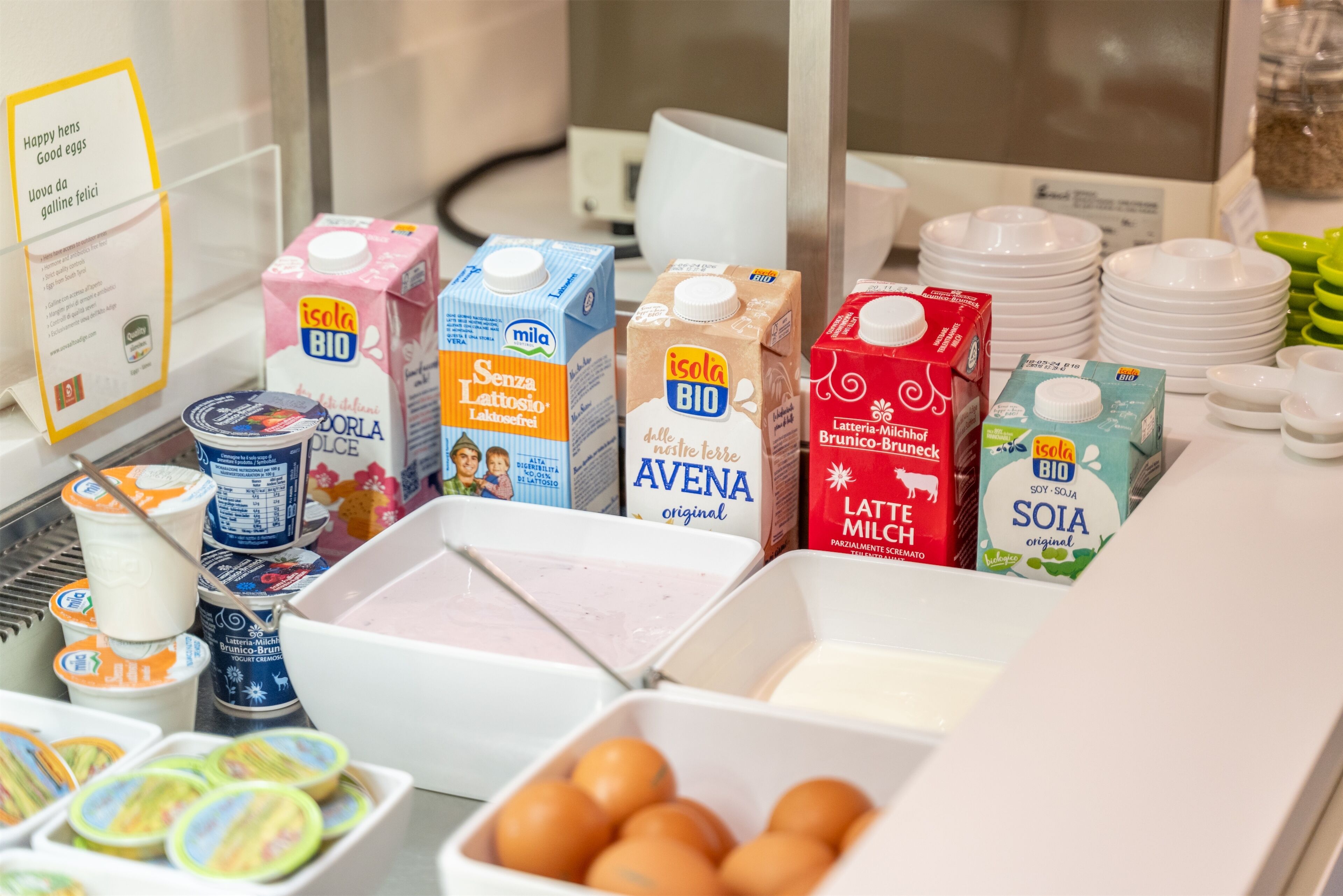 A breakfast buffet with various dairy products and eggs.