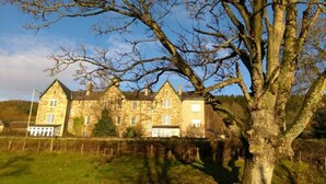 A large stone building with multiple chimneys, likely a historic house or estate. - Cuil an Daraich Guest House (Pitlochry)
