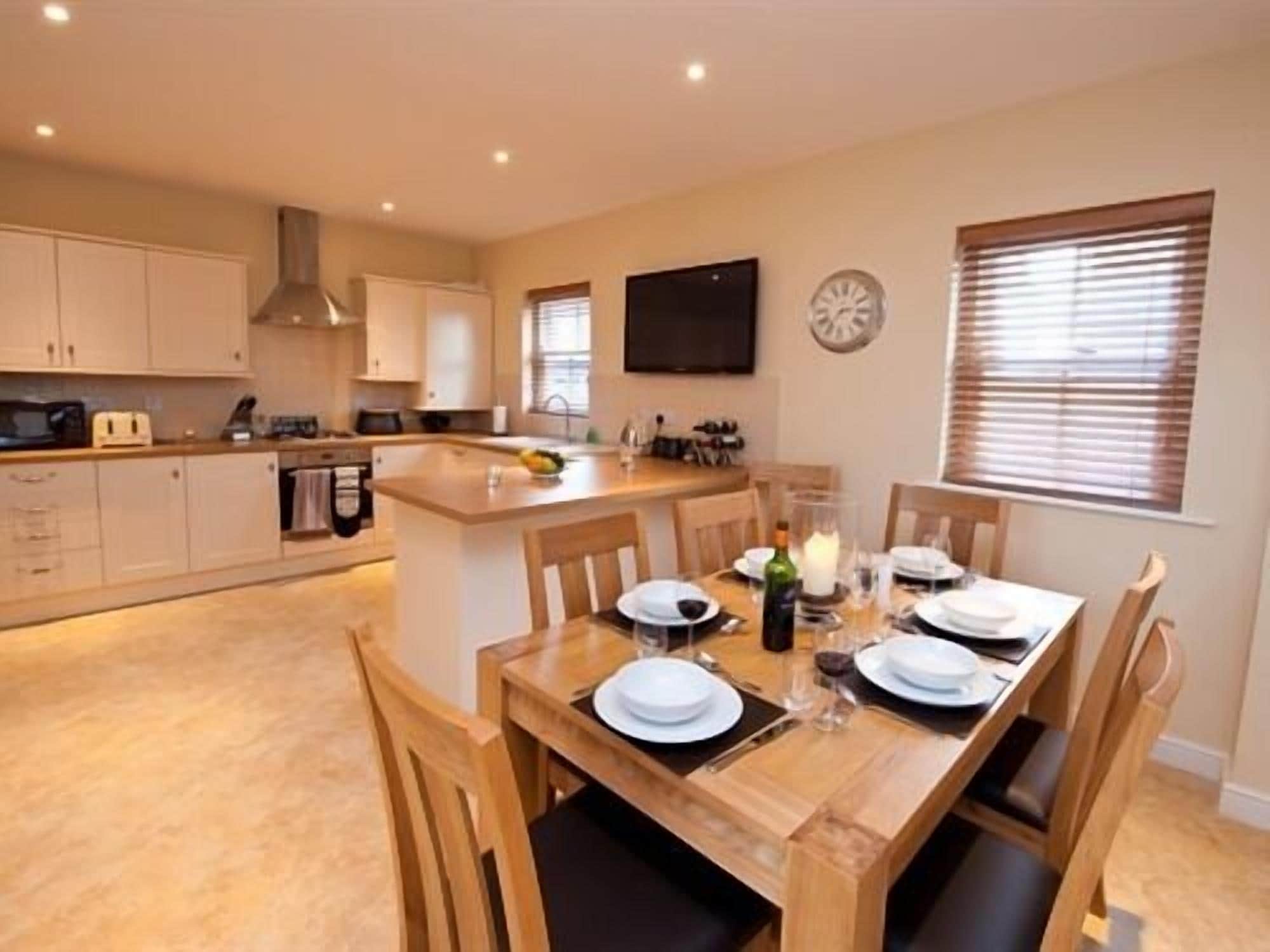 A modern kitchen with a dining area.
